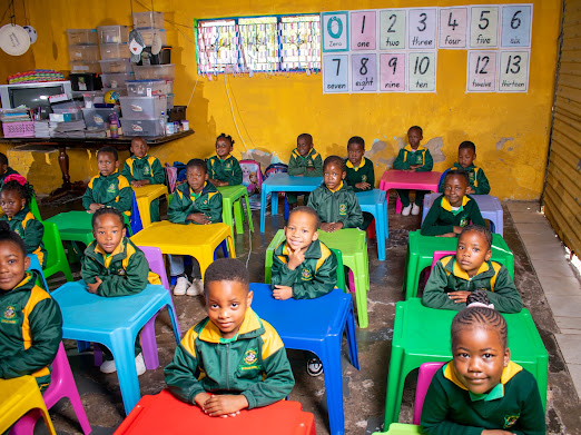 Children seated at colourful classroom tables